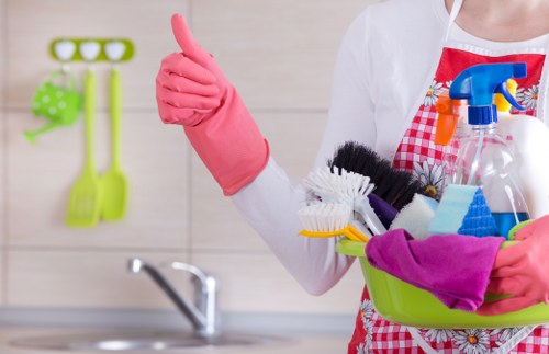 Local oven cleaner working in a compact Kentishtown apartment kitchen