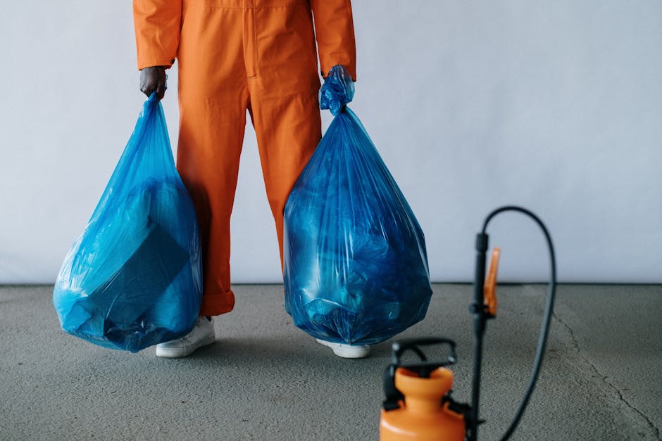 Three professional cleaning specialists from Kentish Town Carpet Cleaners are engaged in surface cleaning within a modern lounge area. The room features a light-colored tiled floor, which is being cle
